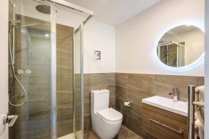 a bathroom with a toilet and a shower and a sink at Flexible Bed Options, Private Back Yard, Car Park in Albert Town +23 photos