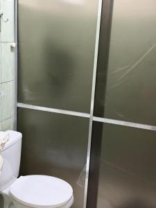 a bathroom with a toilet and a shower stall at Apartamento Estúdio in Macapá