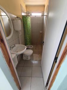a small bathroom with a toilet and a sink at Jr hospedaje C in Paso de los Libres