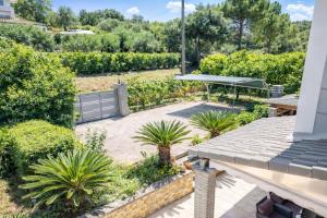 a view of a patio with plants and a roof at Villa Nirvana - Sea View Maisonette in Roda, Offering Tranquility and Comfort on the Enchanting Northern Coast of Corfu in (( Litherés ))