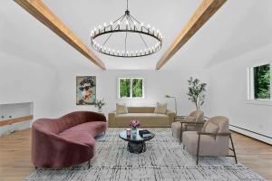 a living room with couches and a chandelier at Renovated Retreat with Heated Pool in Redding