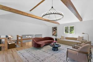 a living room with a couch and a table at Renovated Retreat with Heated Pool in Redding