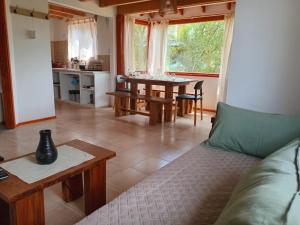 a living room with a couch and a table at Cabañas del Oeste in San Carlos de Bariloche