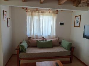 a couch in a room with a window at Cabañas del Oeste in San Carlos de Bariloche