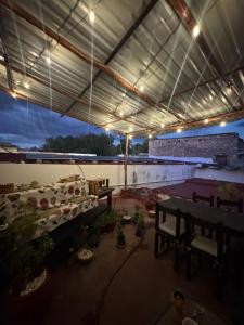 a building with a table and benches in it at Hostal Ixchel - AC, WiFi & Tours in Valladolid Downtown in Valladolid