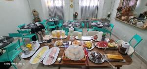a table with plates of food on top at THEHotelBoutiqueCidadeVelha in Belém +28 photos