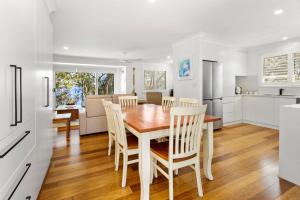 a kitchen and dining room with a table and chairs at Serenity - Pet Friendly with Spa & Waterfront in Sanctuary Point +26 photos
