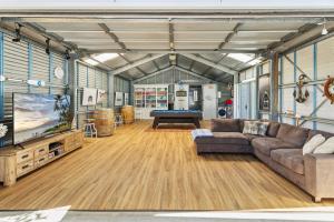a living room with a couch and a pool table at Serenity - Pet Friendly with Spa & Waterfront in Sanctuary Point