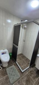 a bathroom with a shower and a toilet at "Refugio campestre familiar - Cálido, cómodo y totalmente equipado" y zona de juegos in Nariño +19 photos