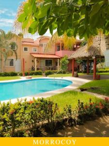 a resort with a swimming pool in front of a building at Casa en Ixtapa 3 recamaras con alberca in Ixtapa