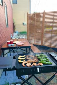 a grill with meat and vegetables on a patio at Japan Family & Kids Castle Hotel Tokyo in Kisarazu