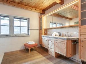 a bathroom with a sink and a mirror at Weberhäusl am Penningberg in Hopfgarten im Brixental +33 photos