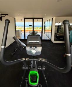 a room with a gym with a treadmill at Stylish 1BR Ocean View near 5th Ave in Playa del Carmen