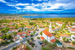 an aerial view of a small town with a church at Apartment Malinska 44 in Malinska