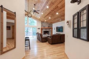 a living room with a couch and a fireplace at Hillside Hideaway - game rm - master spa - Luxury in Lake Arrowhead
