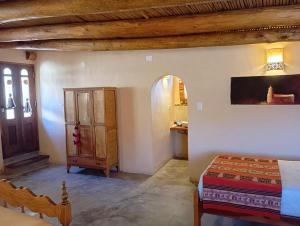 a bedroom with a bed and a wooden ceiling at Sendero De Las Cabras in Purmamarca