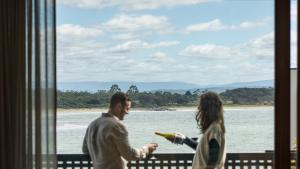a man and a woman standing in front of a window at Piermont Retreat in Swansea