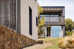 a modern house with a stone wall at Piermont Retreat in Swansea +137 photos
