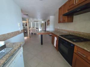 a kitchen with a stove and a counter top at BVG Villa 1 Norte in Ixtapa