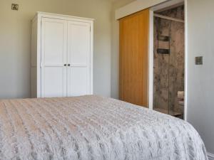 a white bedroom with a bed and a closet at The Wolfs Den - Uk49083 in Winewall +2 photos