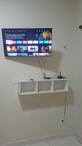 a flat screen tv hanging on a wall at Studio Figueira, Casa in Santarém