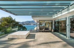 an outdoor patio with a view of the water at Leonardo Royal Hotel Mallorca in Palmanova