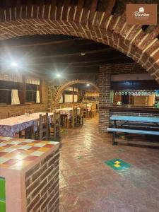 a dining room with tables and a ping pong table at Quinta Bonita in Zacatlán