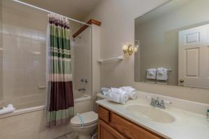 a bathroom with a sink and a toilet and a shower at 1BR Village At Indian Point 601 near SDC-Free Tickets Daily up to $500 in Branson +11 photos
