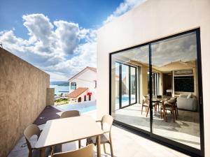 a dining room with a view of the ocean at Kandor Resort Okinawa in Nakijin