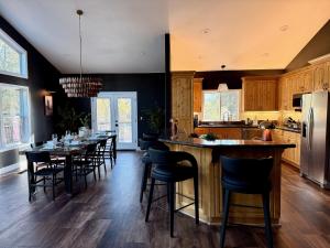 a kitchen with a long table and chairs in it at Elegant Blackwood Grove by Casa Oso in Mariposa +34 photos