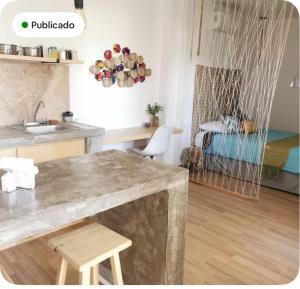 a kitchen with a counter and a table in a room at MaaR Estudios 6, a 2 cuadras del Malecón de La Paz in La Paz +19 photos