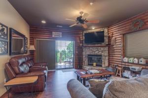 a living room with leather furniture and a fireplace at 1BR Village At Indian Point 2102 near SDC-Free Tickets Daily up to $500 in Branson