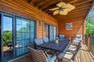 a patio with a table and chairs on a deck at 1BR Village At Indian Point 2102 near SDC-Free Tickets Daily up to $500 in Branson