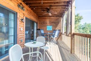 a wooden deck with a table and chairs on it at 2BR Village At Indian Point 1202 near SDC-Free Tickets Daily up to $500 in Branson