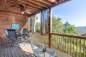 a wooden deck with a table and chairs on it at 2BR Village At Indian Point 1202 near SDC-Free Tickets Daily up to $500 in Branson