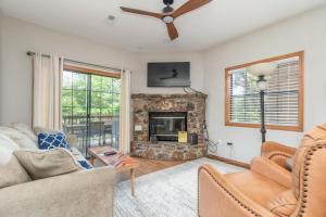 a living room with a fireplace and a ceiling fan at 1BR Village At Indian Point 1104 near SDC-Free Tickets Daily up to $500 in Branson