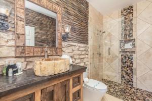 a bathroom with a sink and a toilet and a mirror at 1BR Village At Indian Point 1104 near SDC-Free Tickets Daily up to $500 in Branson +11 photos