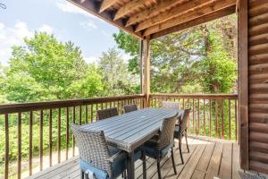 a wooden deck with a table and chairs on it at 1BR Village At Indian Point 1104 near SDC-Free Tickets Daily up to $500 in Branson