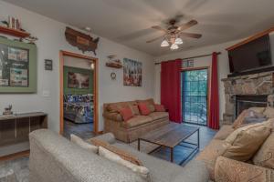 a living room with two couches and a fireplace at 1BR Village At Indian Point 2004 near SDC-Free Tickets Daily up to $500 in Branson