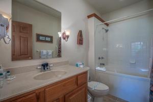 a bathroom with a sink and a toilet and a tub at 1BR Village At Indian Point 2004 near SDC-Free Tickets Daily up to $500 in Branson +8 photos