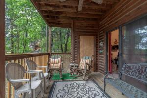 a porch of a cabin with chairs and a couch at 1BR Village At Indian Point 2004 near SDC-Free Tickets Daily up to $500 in Branson