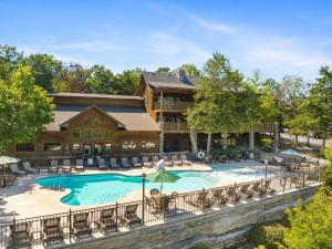 an exterior view of a resort with a swimming pool at 2BR Village At Indian Point 501 near SDC-Free Tickets Daily up to $500 in Branson