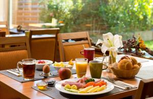 a table topped with plates of food and drinks at Leonardo Hotel Karlsruhe in Karlsruhe +47 photos