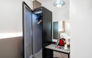 a room with a mirror and a counter with a table at Songdo The Seoleim Hotel Stay in Incheon