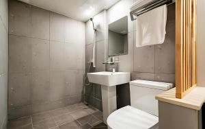 a bathroom with a sink and a toilet at Songdo The Seoleim Hotel Stay in Incheon