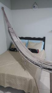 a bed with a net on it in a room at Ap do Jhone in Canoa Quebrada