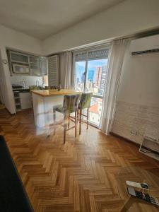 a kitchen with a table and chairs and a large window at Aire Porteño in La Porteña