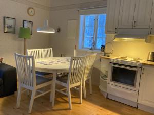 a kitchen with a table and chairs in a kitchen at Huså Herrgård in Järpen +5 photos