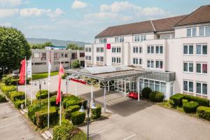 an overhead view of a building with red flags at Leonardo Hotel Aachen in Aachen