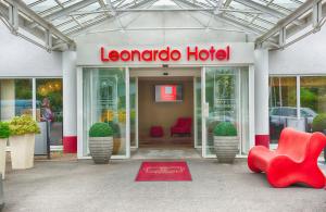 a store front with a red chair and a hotel at Leonardo Hotel Heidelberg in Heidelberg